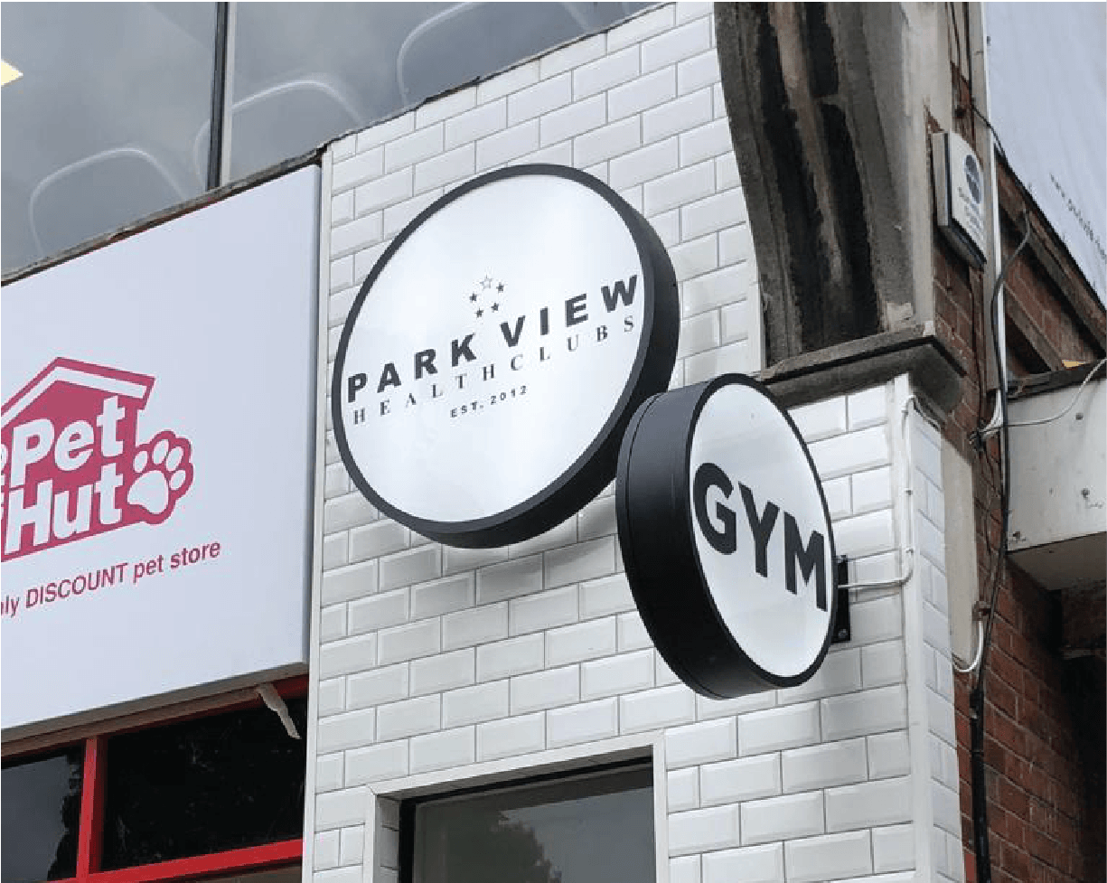 Metal illuminated circular entrance and projecting light box signs for gym in London Kalay creative